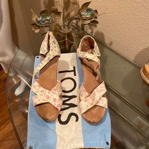 Floral pink, and light blue Toms wedges.